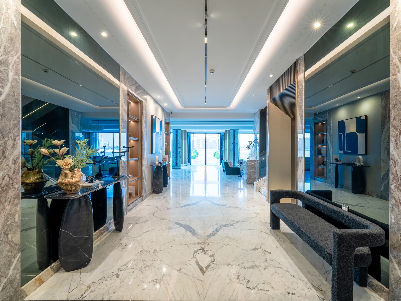 Grand entry hallway with marble and art